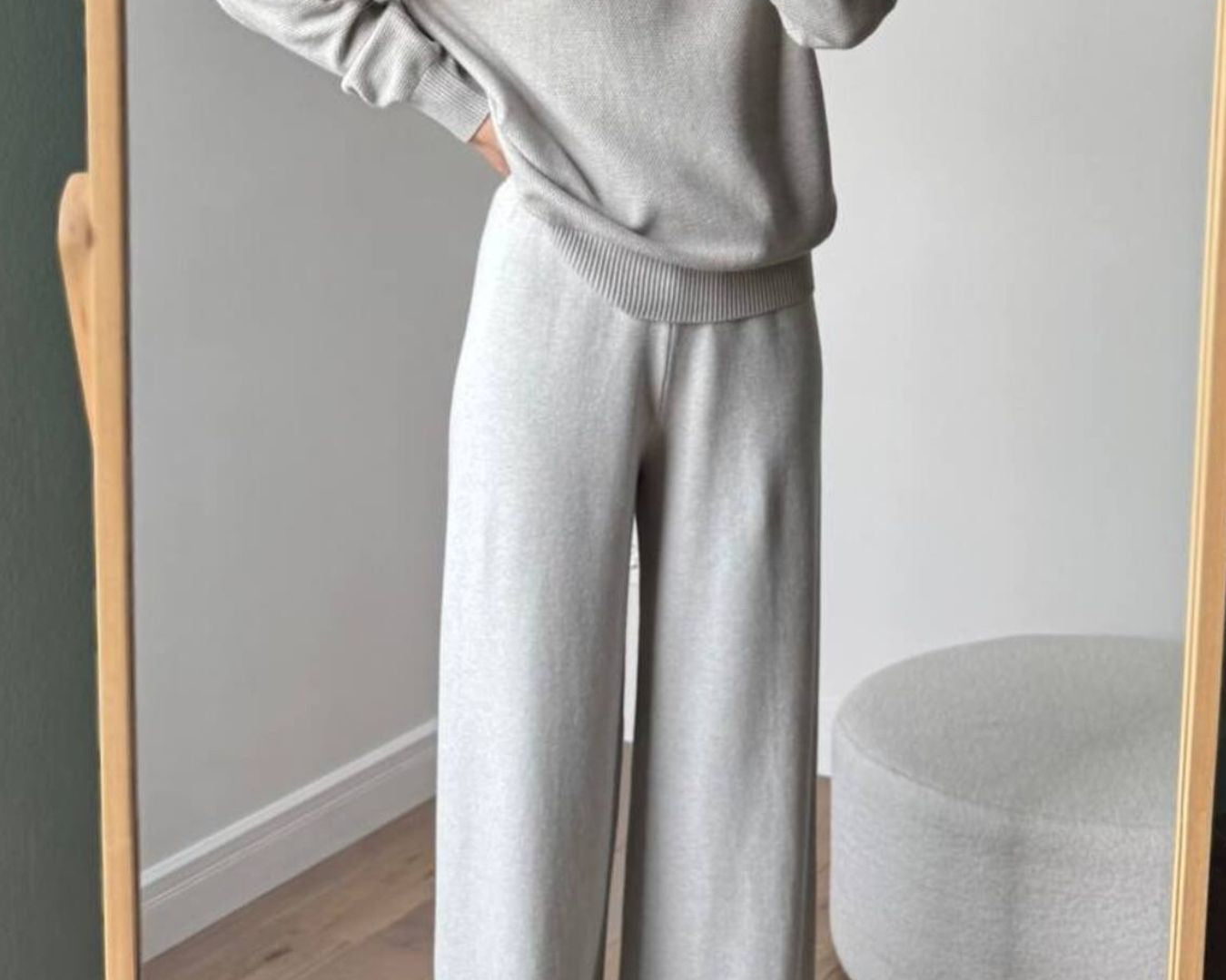 NEWYORKLISTED Comfort Collection: Person wearing a gray sweater and pants standing in front of a mirror.