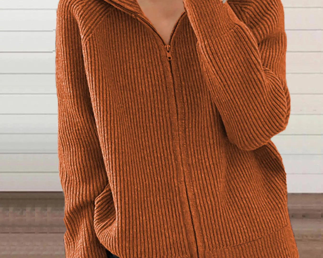 NEWYORKLISTED STYLE COLLECTION:Person wearing a brown ribbed sweater with a zipper against a neutral background
