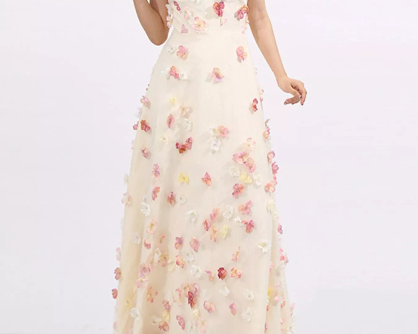 NEWYORKLISTED STYLE COLLECTION: Woman wearing a strapless floral gown on a white background