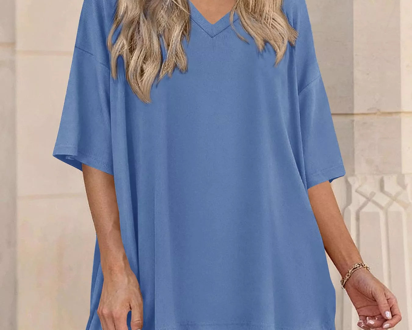 NEWYORKLISTED COMFORT COLLECTION: Woman wearing a blue outfit with a matching top and shorts in front of a beige wall.