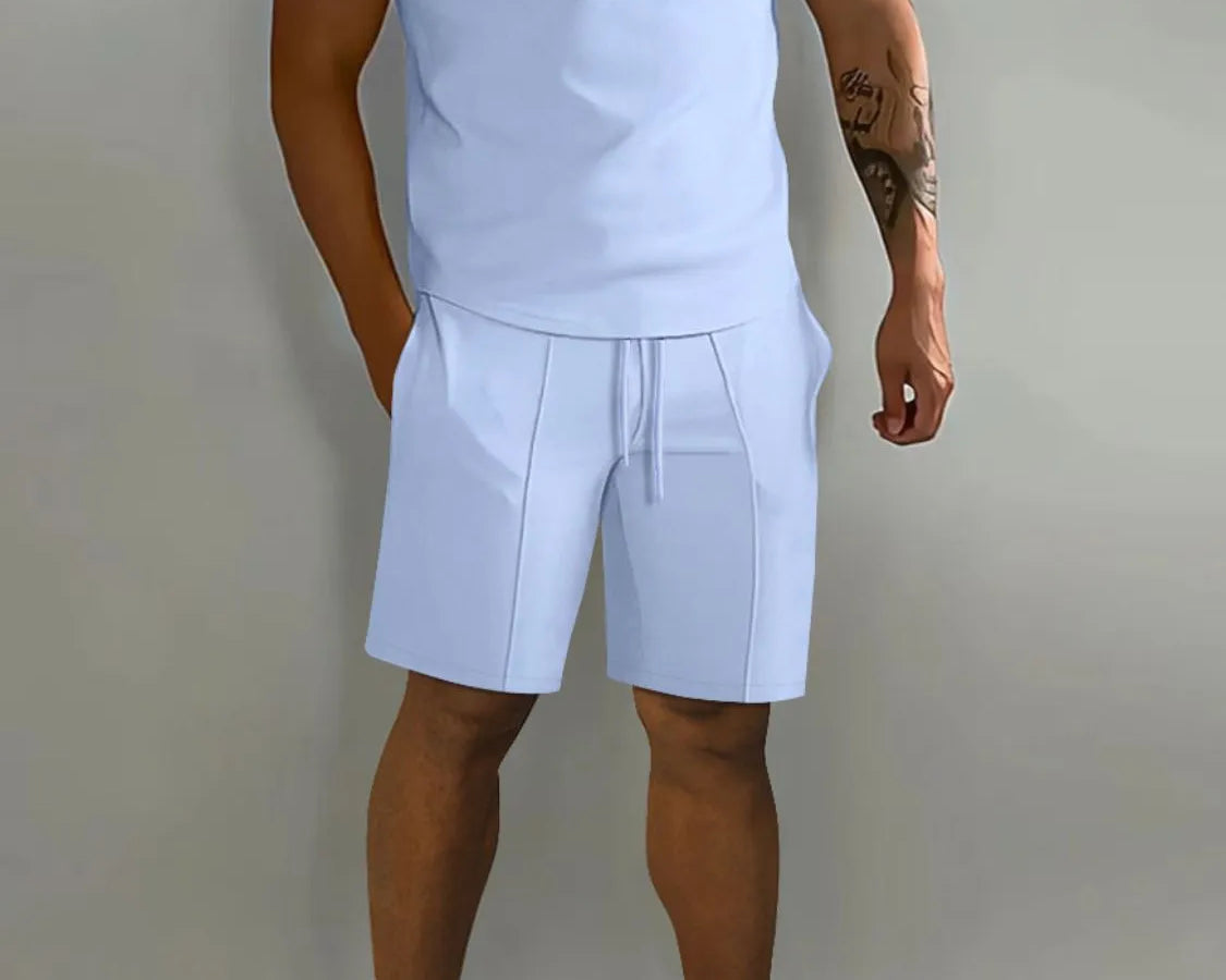 NEWYORKLISTED ATLAS MEN's COLLECTION: Person wearing a light blue polo shirt and shorts set with white sneakers on a plain background