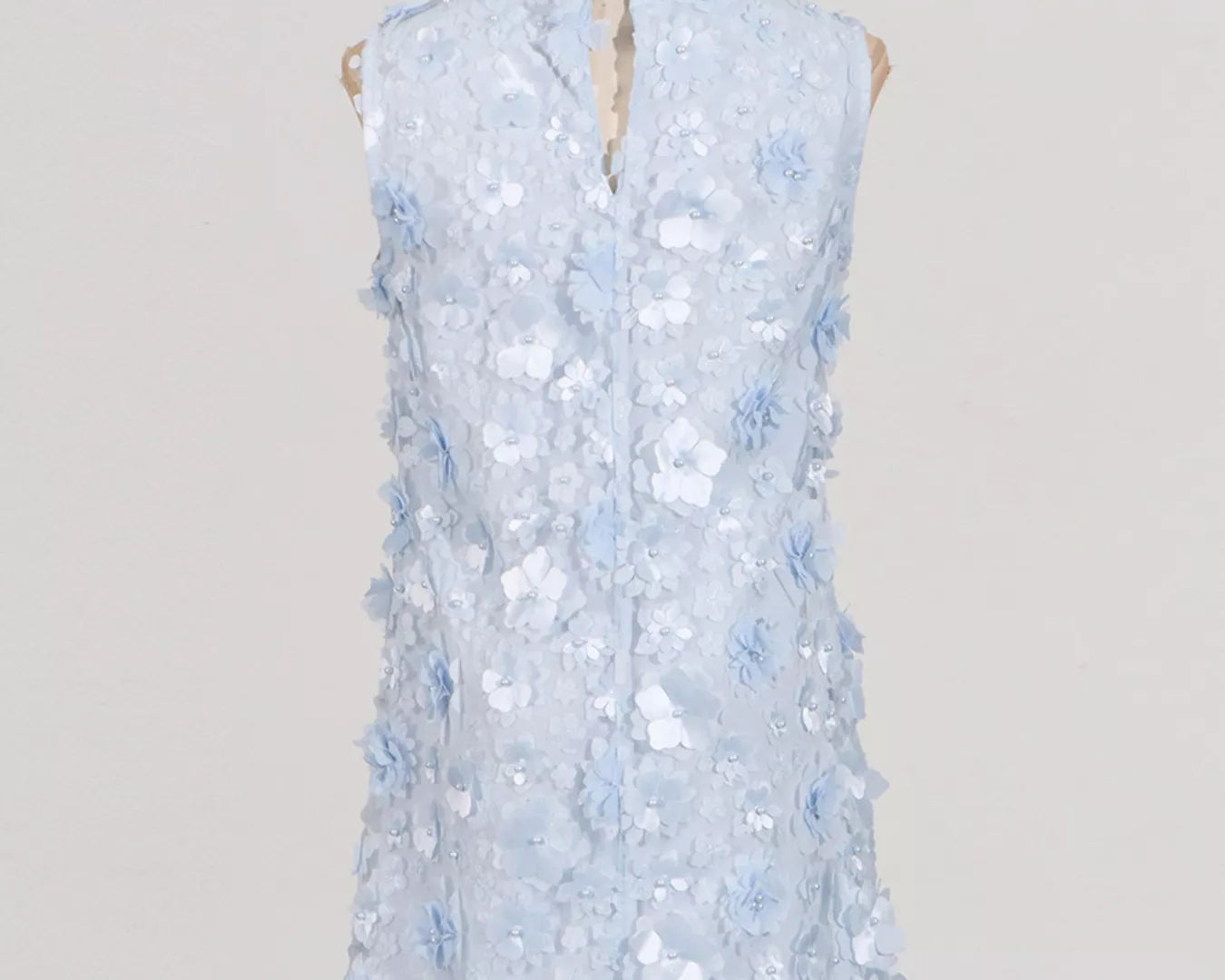 NEWYORKLISTED STYLE COLLECTION: Light blue sleeveless dress on a mannequin against a plain background