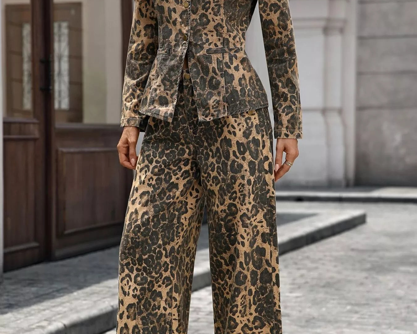 NEWYORKLISTED STYLE COLLECTION: Person wearing a leopard print suit standing on a street.
