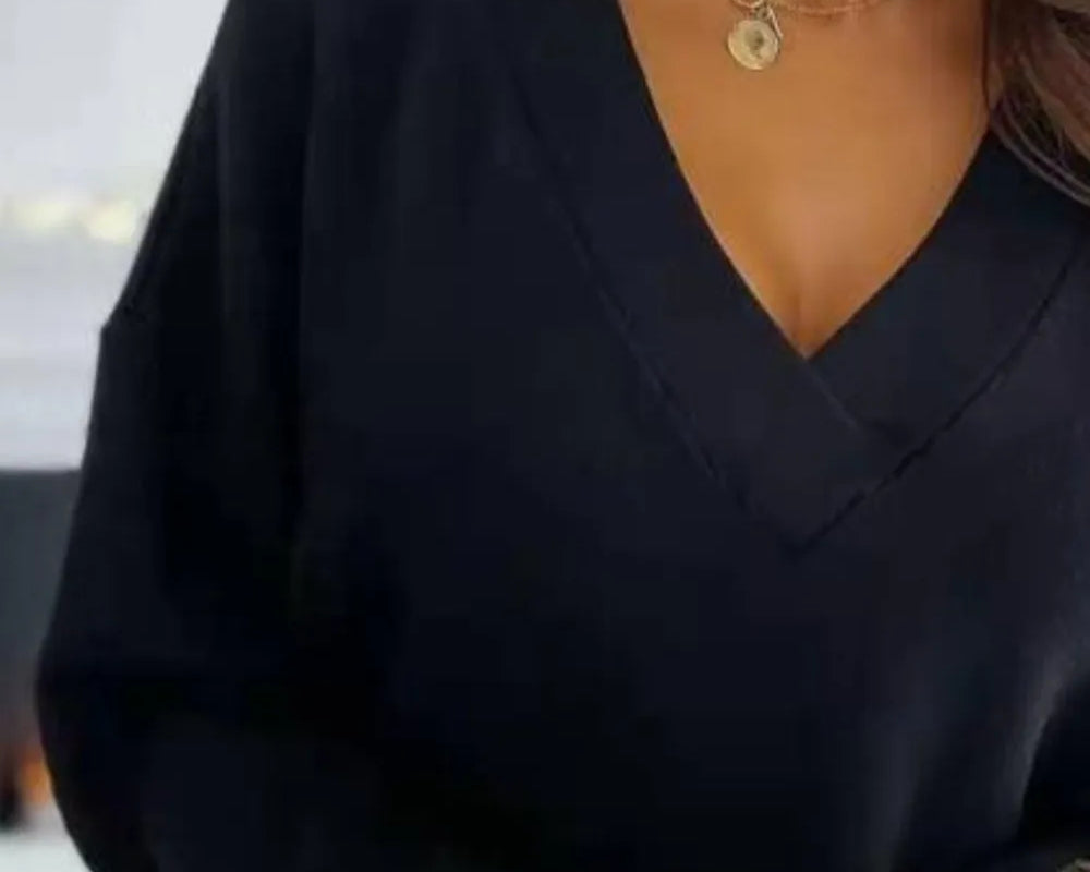 NEWYORKLISTED STYLE COLLECTION: Person wearing a black outfit with gold jewelry and a blurred background
