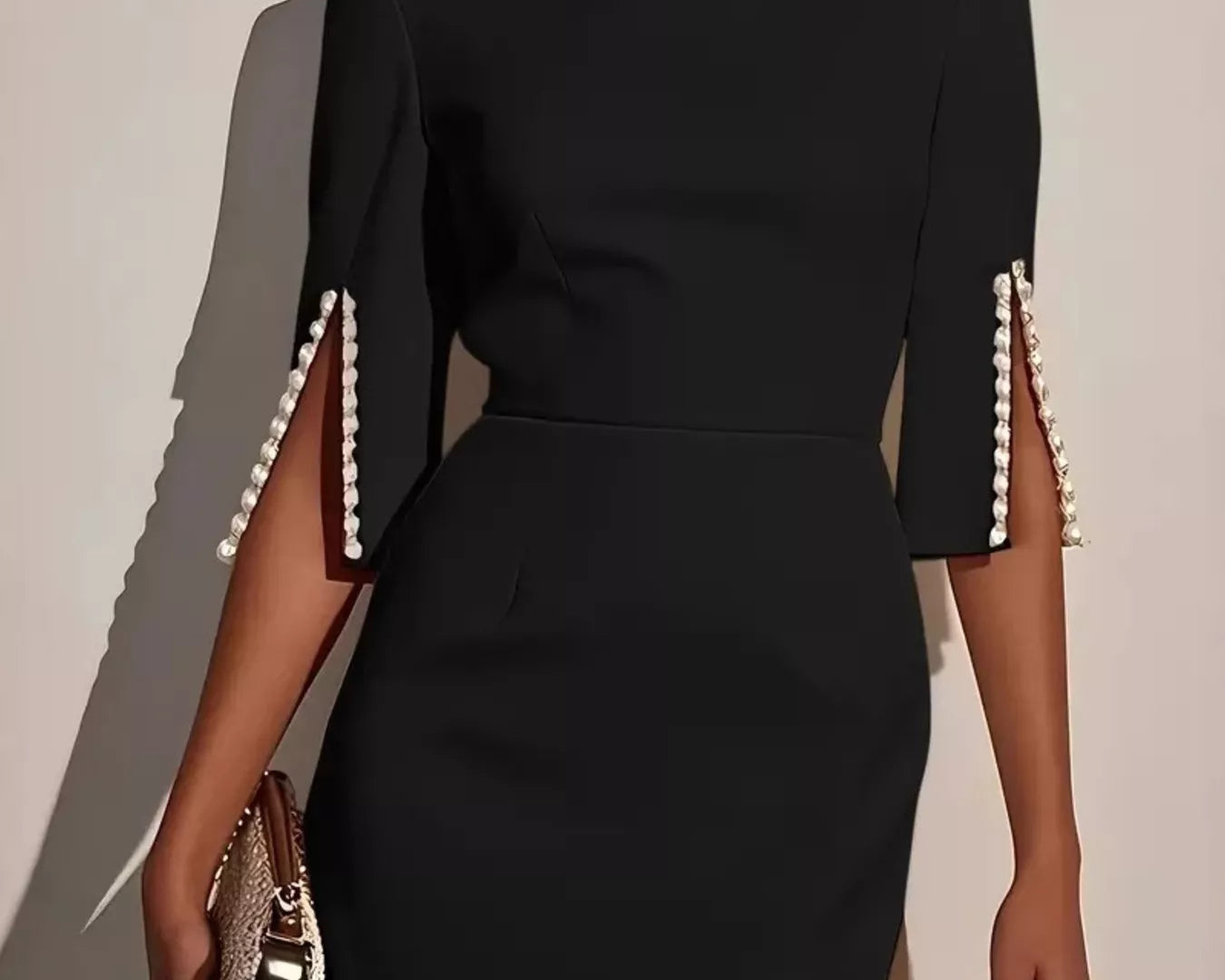 NEWYORKLISTED STYLE COLLECTION: Black dress with pearl shoulder details on a neutral background