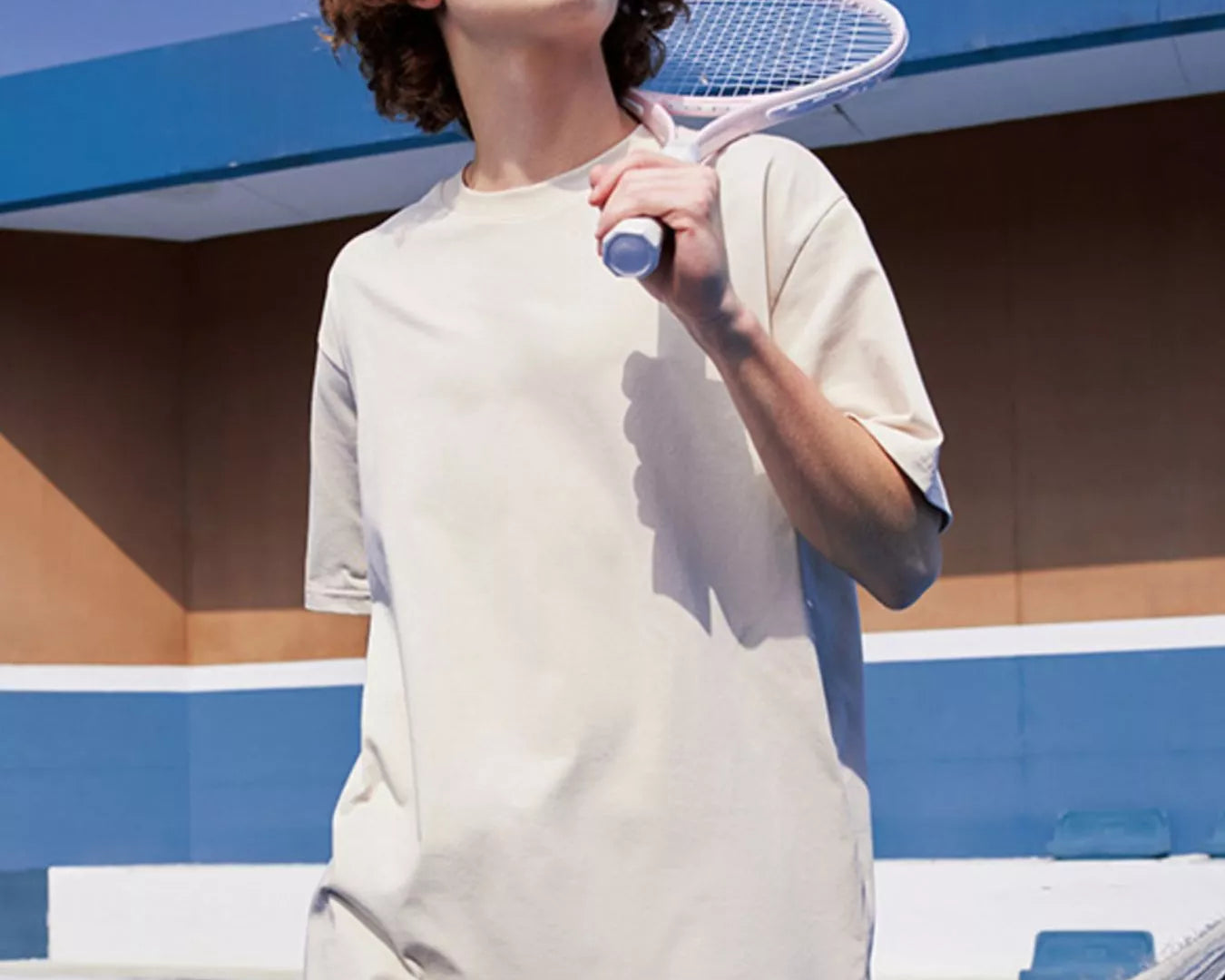 NEWYORKLISTED ATLAS MEN's COLLECTION: Person holding a tennis racket on a tennis court with a blue sky background