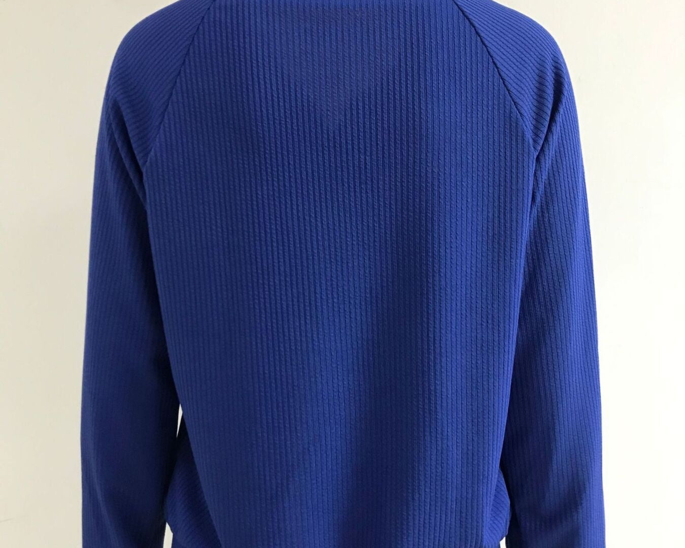 NEWYORKLISTED STYLE COLLECTION: Blue sweater on a mannequin against a white background