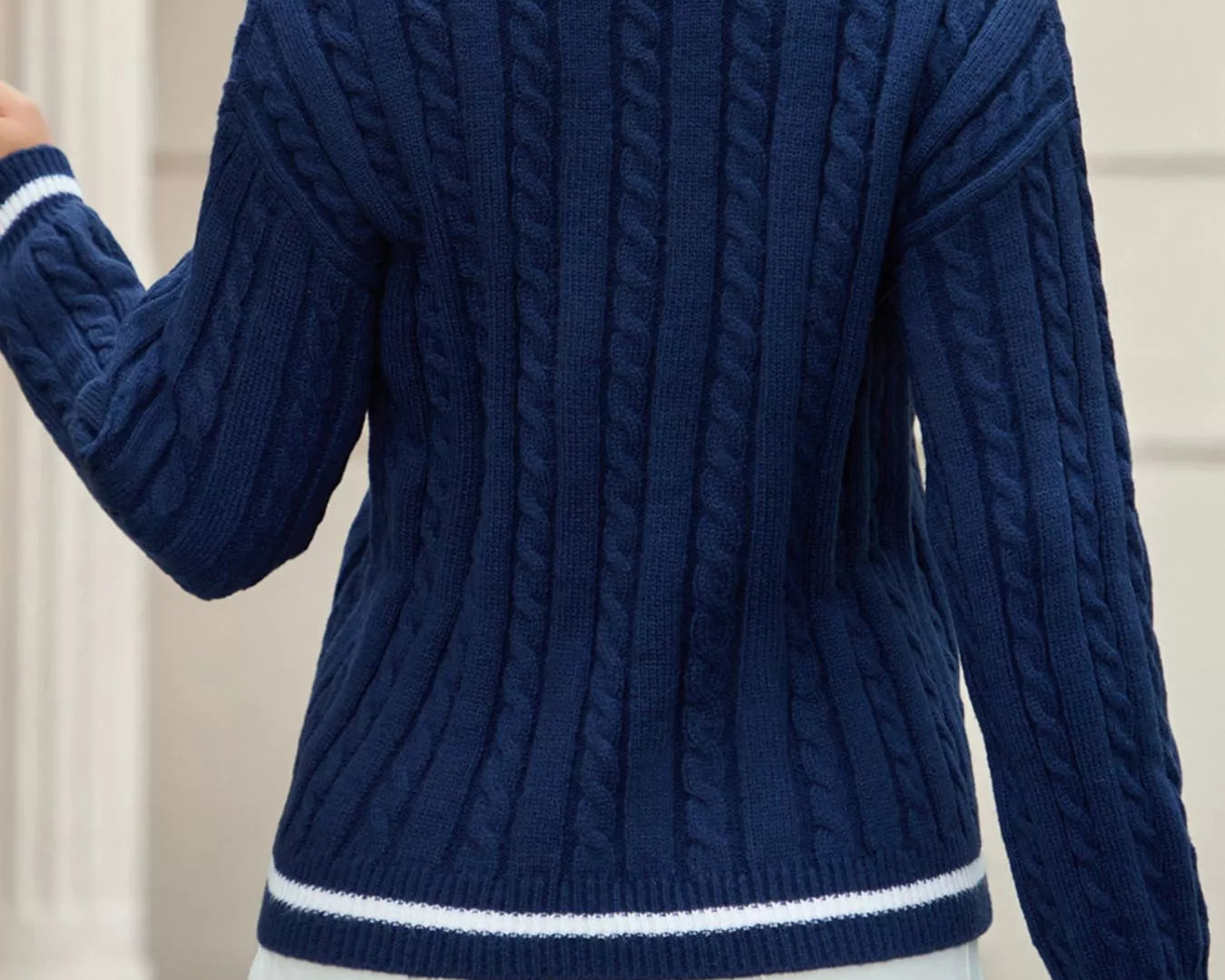NEWYORKLISTED STYLE COLLECTION: Person wearing a blue cable knit sweater with white trim