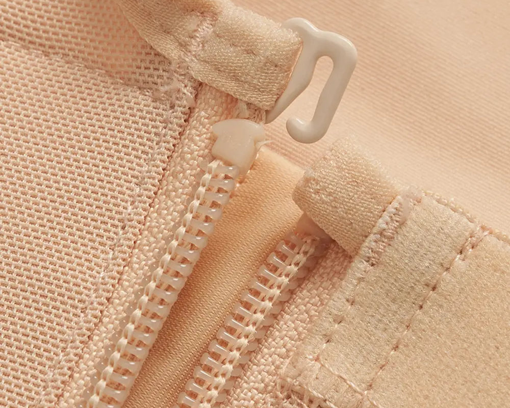 NEWYORKLISTED Intimate Apparel: Close-up of a beige fabric with a zipper and button