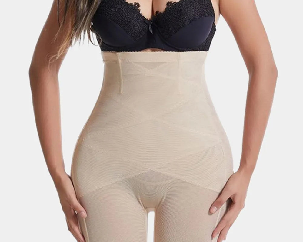 NEWYORKLISTED Intimate Apparel: Woman wearing a black lace bra and beige shapewear on a white background