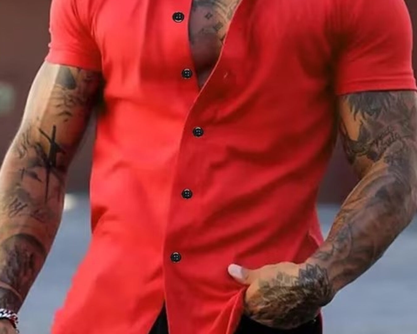NEWYORKLISTED ATLAS MEN's COLLECTION: Man wearing a red button-up shirt with tattoos on arms and chest.