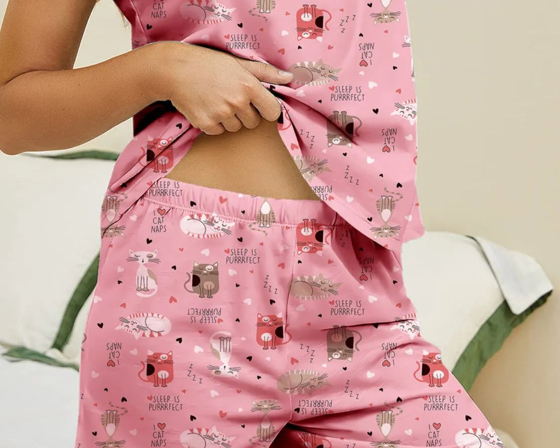 NEWYORKLISTED Intimate Apparel: Pink pajama set with animal print worn by a person, on a neutral background.