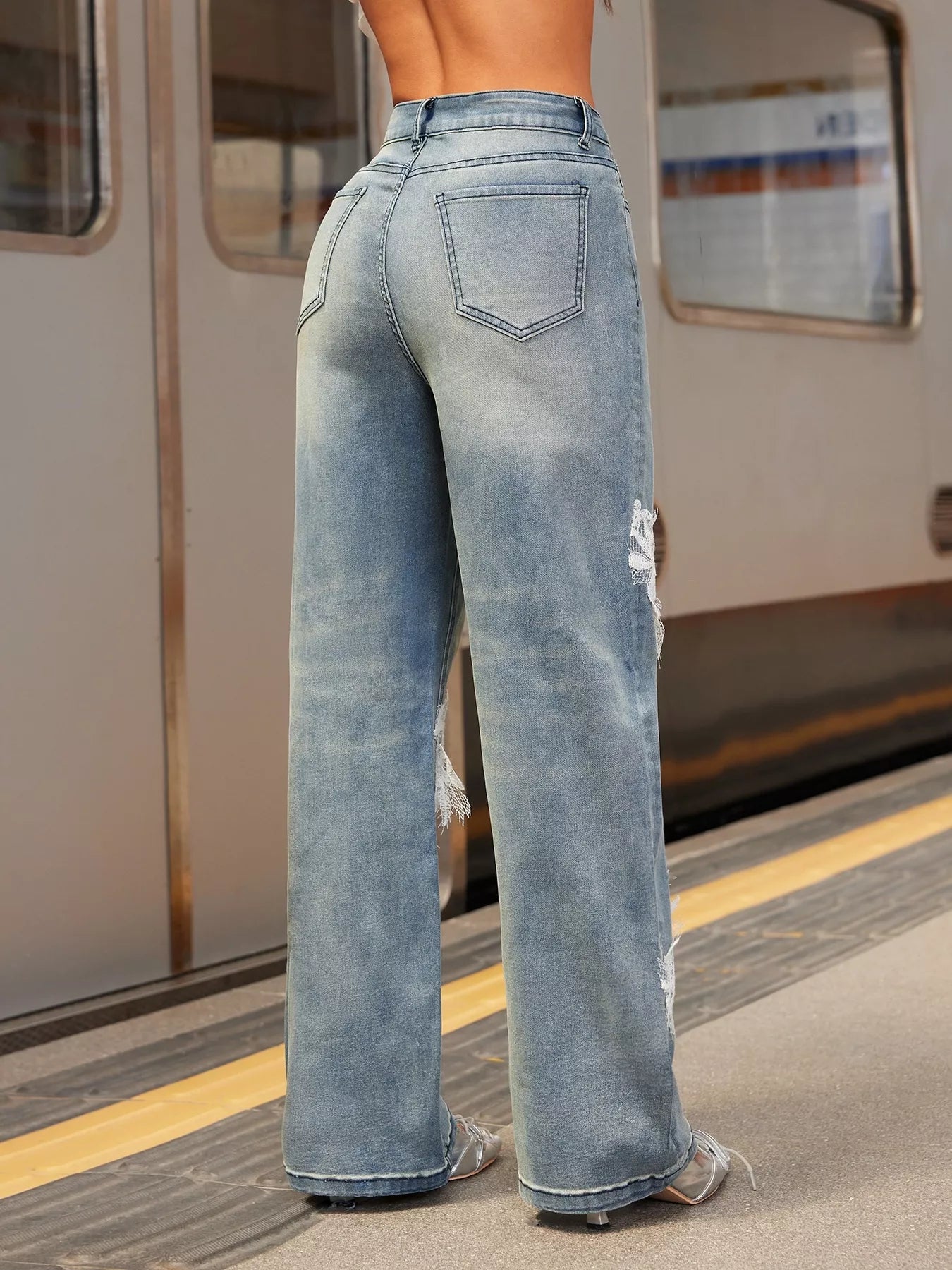 NEWYORKLISTED STYLE COLLECTION: Person wearing light blue jeans on a train platform