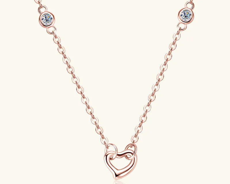 NEWYORKLISTED Valentine’s Day Specials: Rose gold necklace with a heart-shaped pendant on a white background