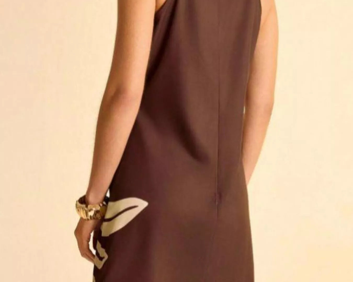 NEWYORKLISTED STYLE COLLECTION: Brown dress worn by a person on a beige background