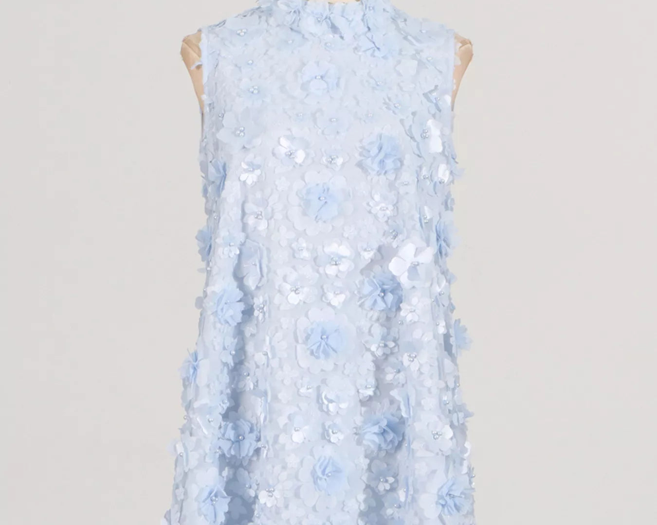 NEWYORKLISTED STYLE COLLECTION: Light blue floral dress on a mannequin against a plain background