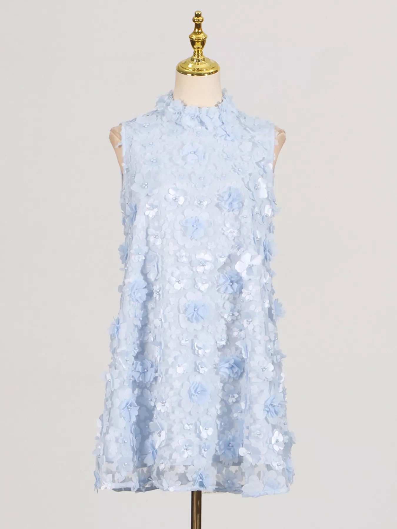 NEWYORKLISTED STYLE COLLECTION: Light blue floral dress on a mannequin against a plain background