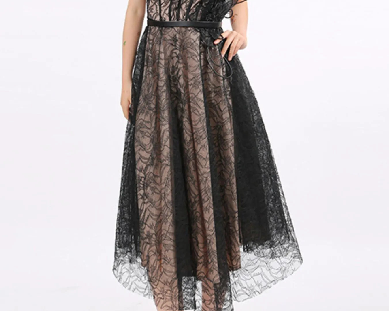 NEWYORKLISTED RUNWAY STYLE: Black lace dress worn by a model on a white background