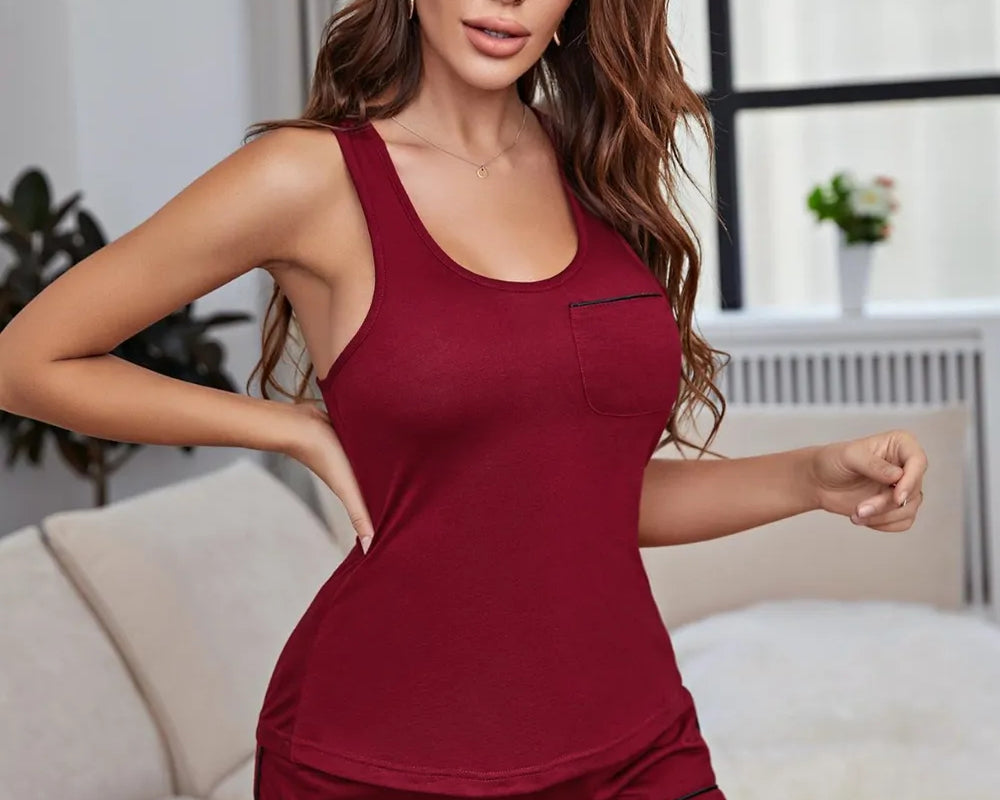 NEWYORKLISTED Intimate Apparel Collection: Woman wearing a burgundy tank top and shorts set in a living room.
