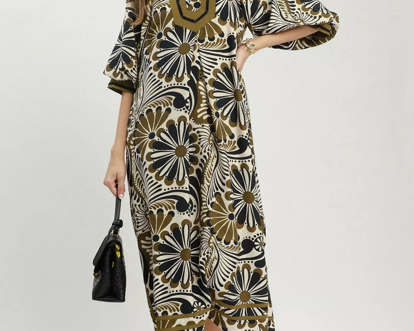 NEWYORKLISTED STYLE COLLECTION: Woman wearing a patterned dress with a white background