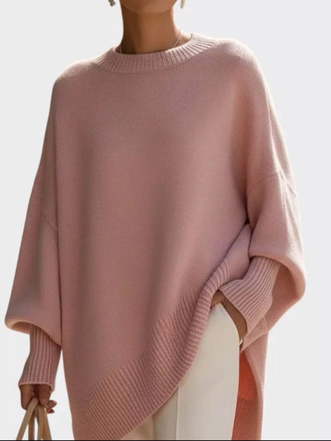 NEWYORKLISTED STYLE COLLECTION: Pink sweater worn by a person on a light gray background