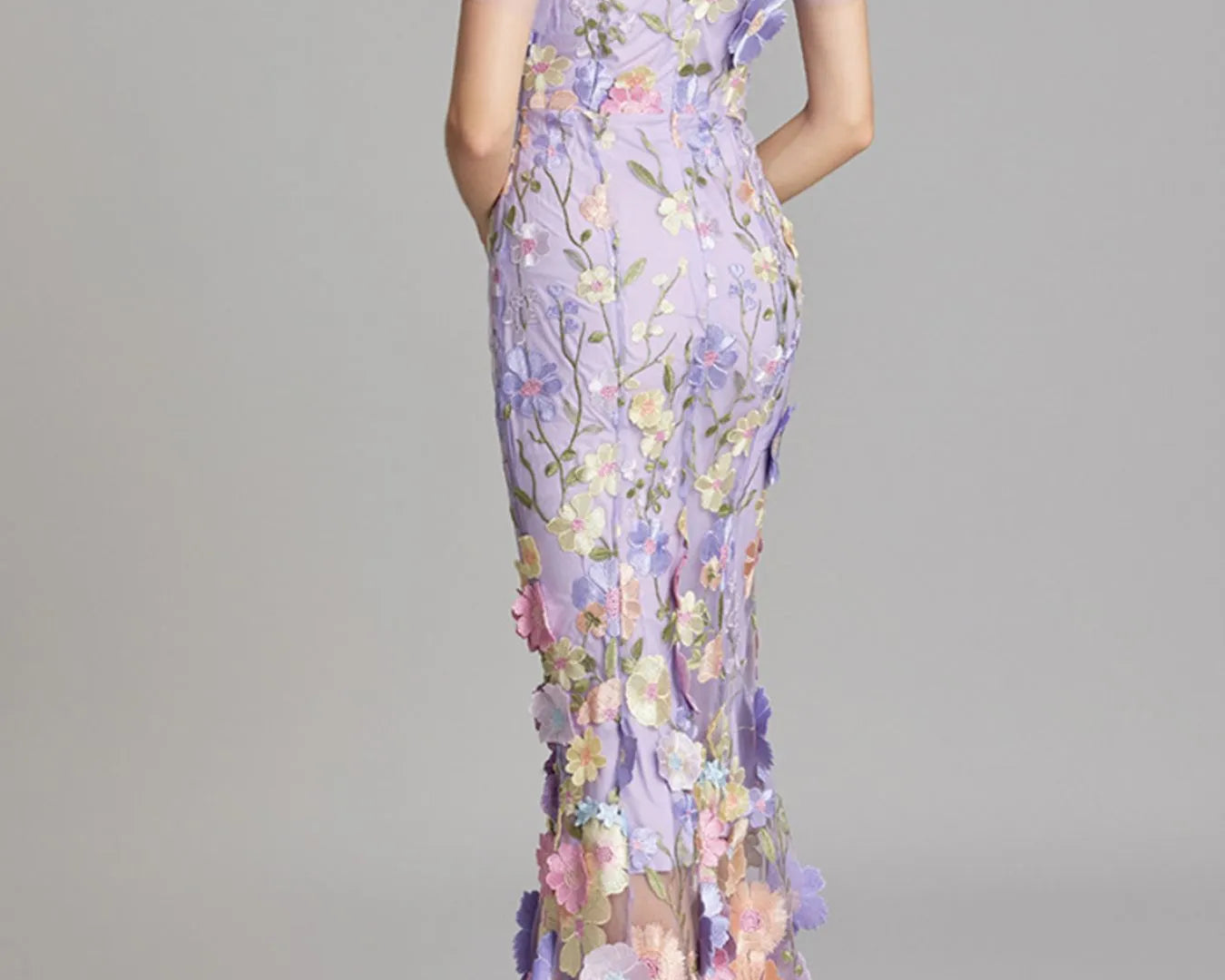 NEWYORKLISTED STYLE COLLECTION: Woman wearing a floral dress with a gray background