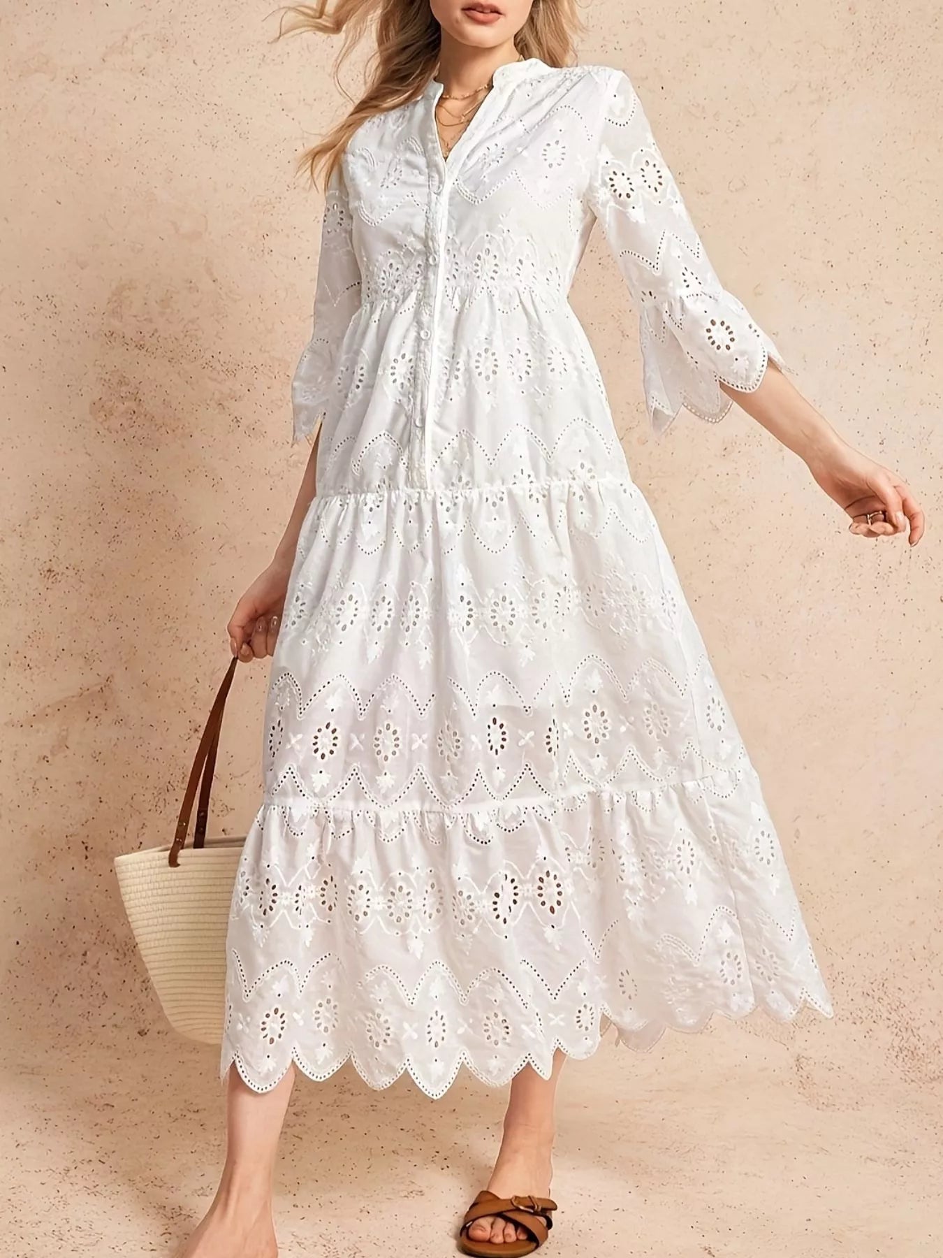 NEWYORKLISTED STYLE COLLECTION: Woman wearing a white lace dress against a beige background