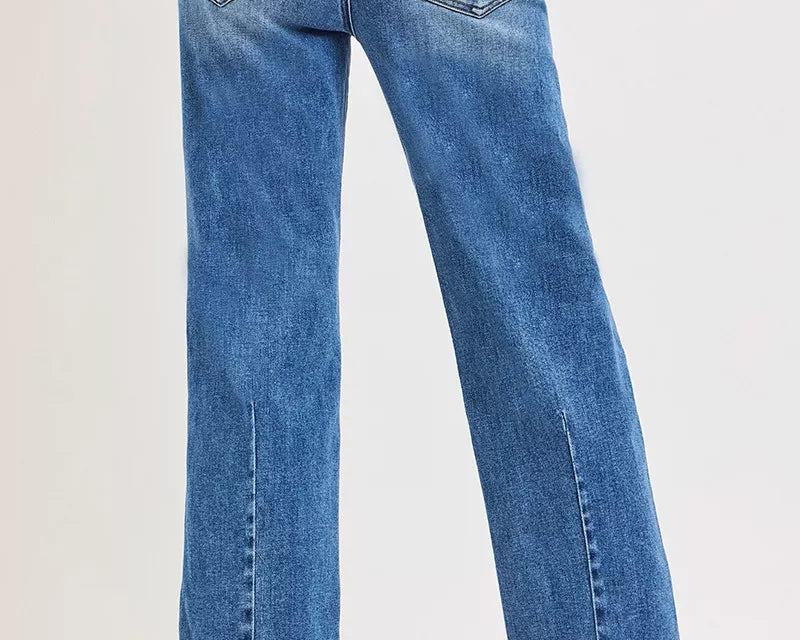 NEWYORKLISTED DENIM COLLECTION: Blue jeans worn by a person on a white background