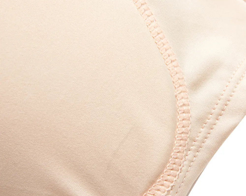 NEWYORKLISTED Intimate Apparel: Close-up of a beige bra strap on a white background