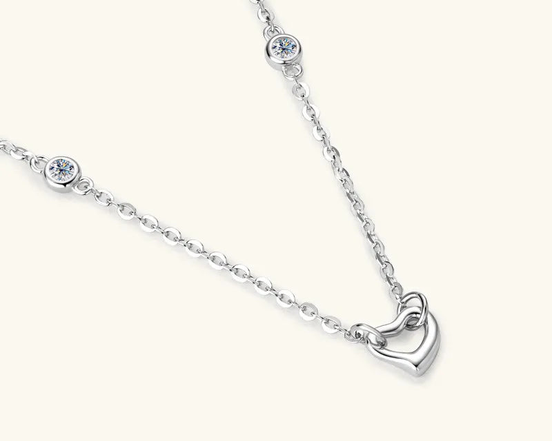 NEWYORKLISTED Valentine’s Day Specials: Silver necklace with a heart-shaped pendant on a white background