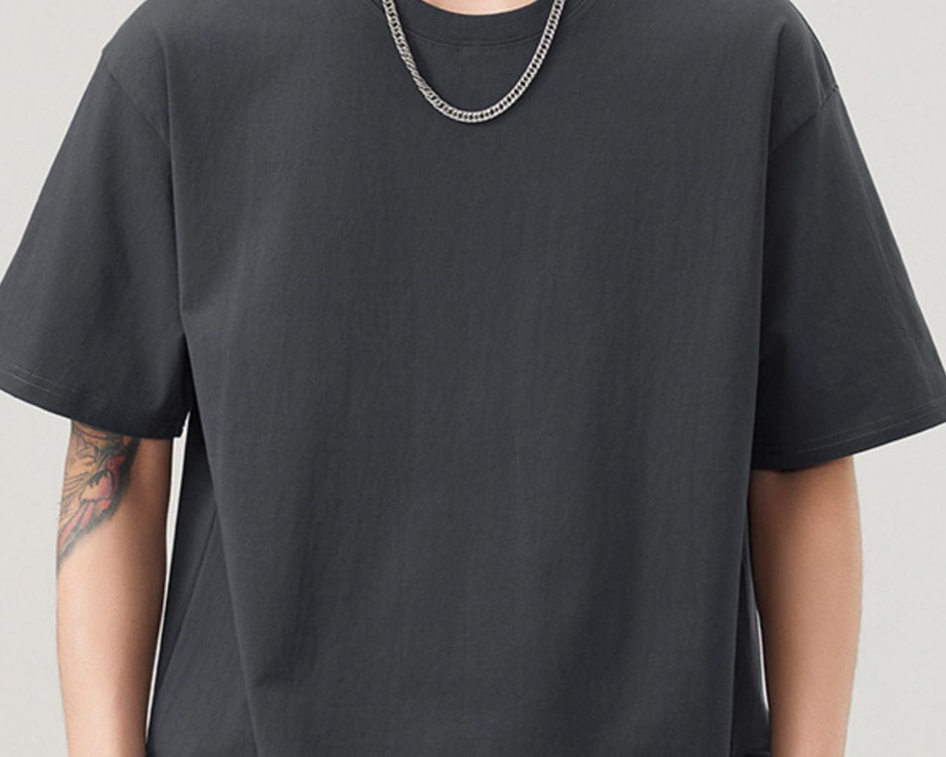 NEWYORKLISTED ATLAS MEN"S COLLECTION: Person wearing a black t-shirt and beige pants on a plain background