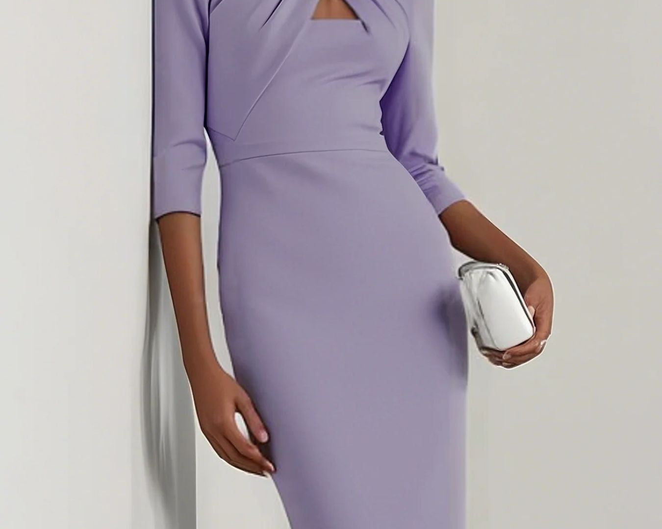 NEWYORKLISTED STYLE COLLECTION: Woman wearing a purple dress holding a clutch against a plain background