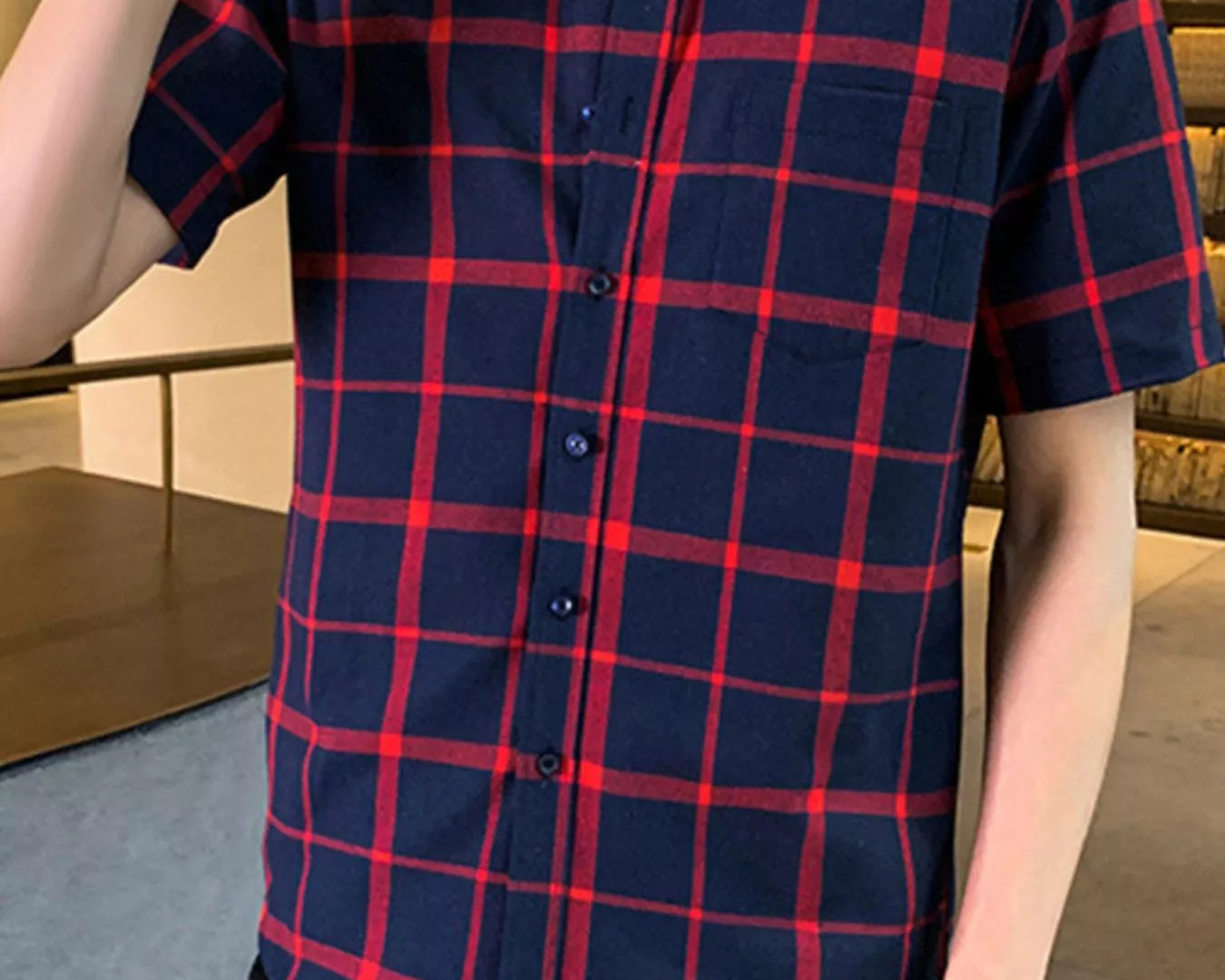 NEWYORKLISTED ATLAS MEN'S COLLECTION: Person wearing a red and blue plaid shirt indoors.