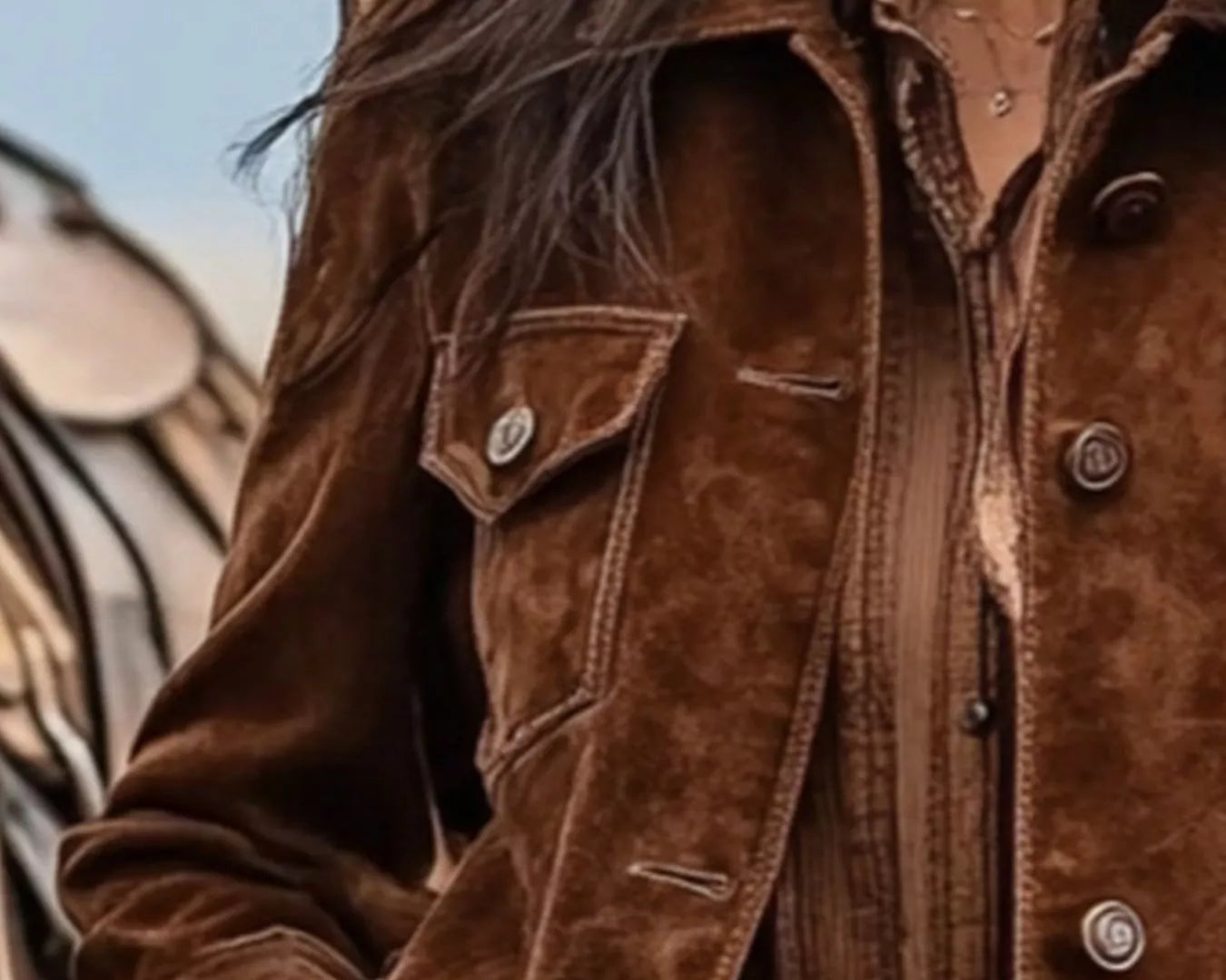 NEWYORKLISTED STYLE COLLECTION: Brown suede jacket worn by a person with a zebra in the background