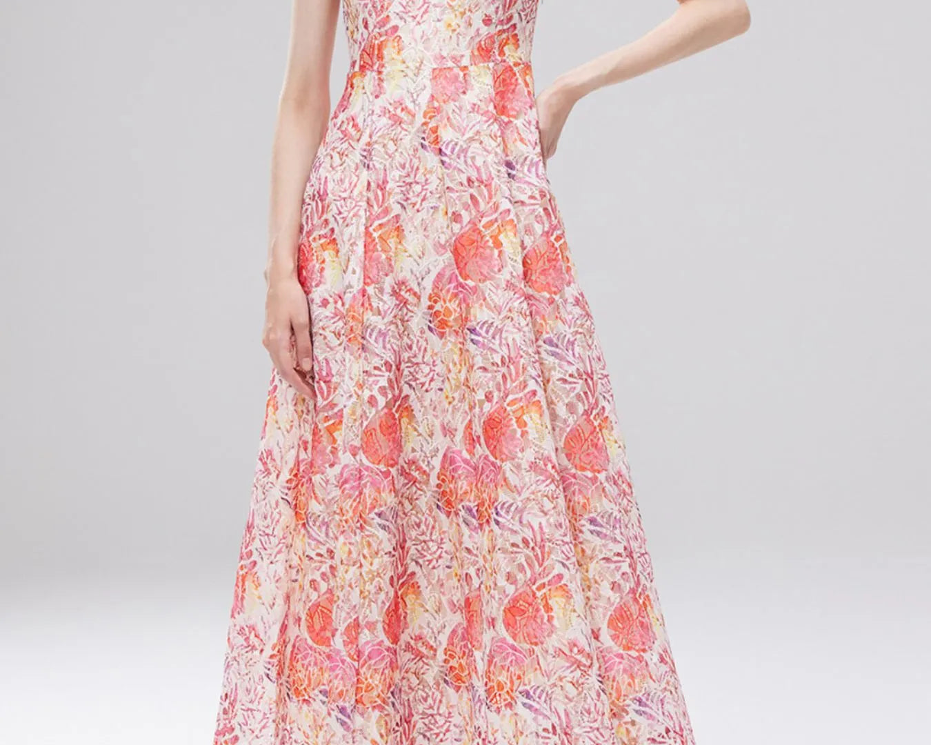 NEWYORKLISTED STYLE COLLECTION: Woman wearing a floral dress on a gray background