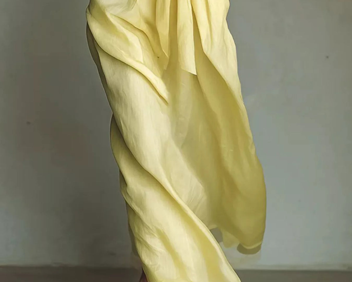 NEWYORKLISTED STYLE COLLECTION: Yellow dress with a plain background