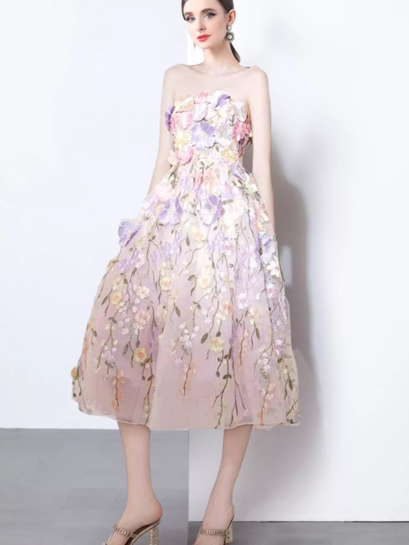 NEWYORKLISTED STYLE COLLECTION: Woman wearing a floral strapless dress on a white background