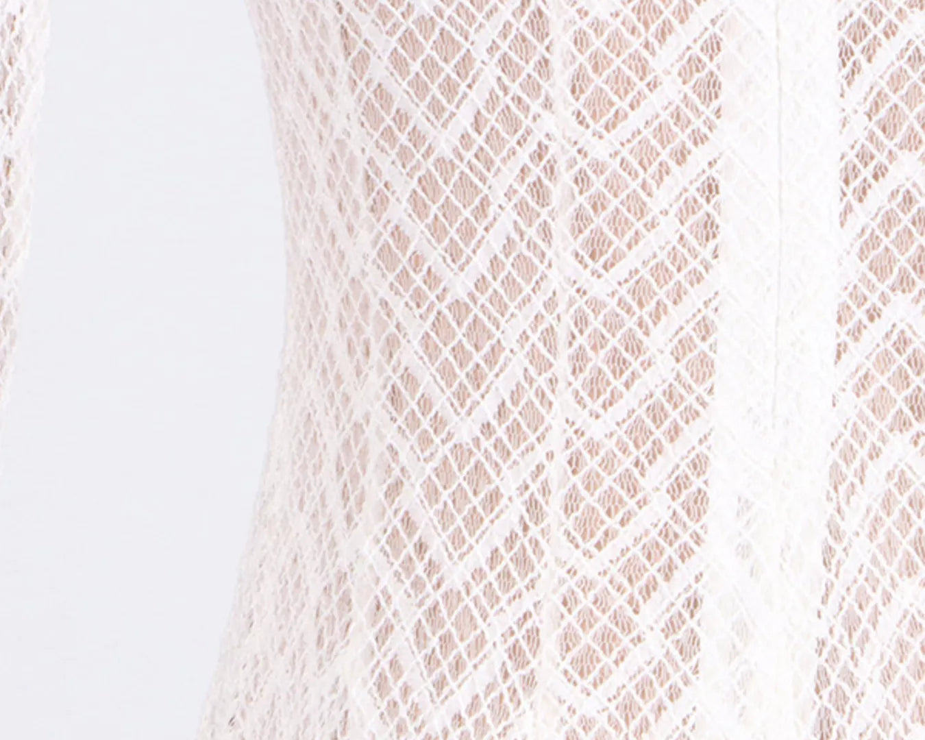 NEWYORKLISTED STYLE COLLECTION: Close-up of a textured fabric with a diamond pattern on a light background
