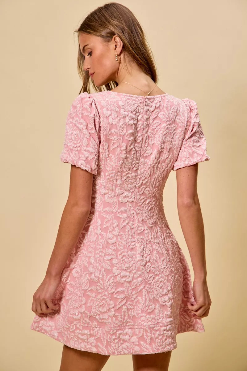 NEWYORKLISTED STYLE COLLECTION: Woman wearing a pink floral dress against a beige background