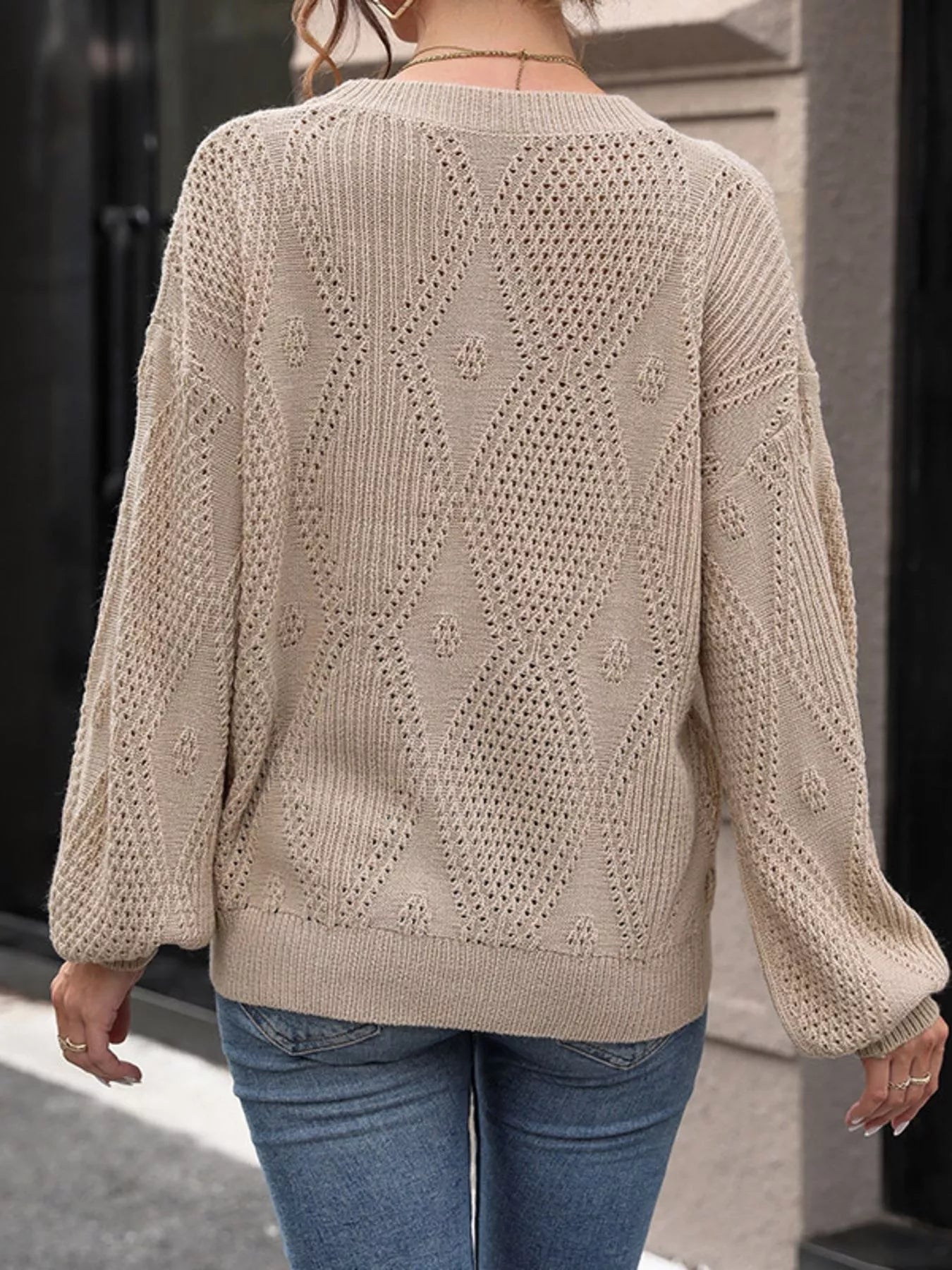 NEWYORKLISTED STYLE COLLECTION: Beige knitted sweater with a geometric pattern worn by a person, standing against a neutral background.