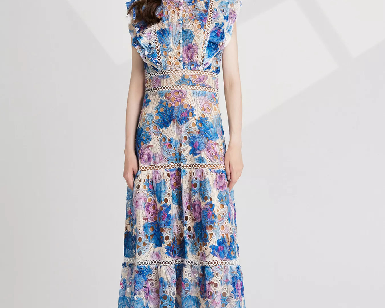 NEWYORKLISTED STYLE COLLECTION: Woman wearing a floral dress on a white background