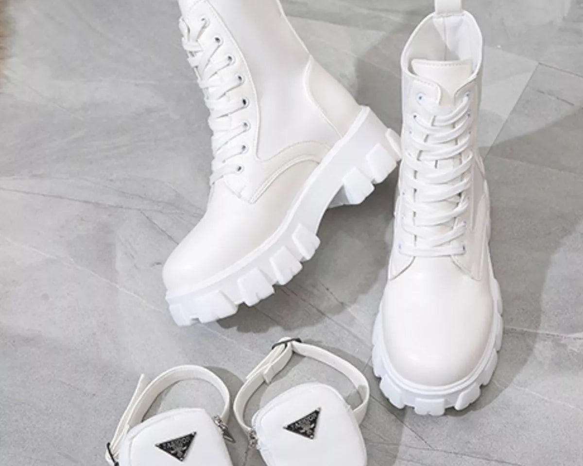 NEWYORKLISTED SHOE COLLECTION: White boots and matching pouches on a light wooden floor