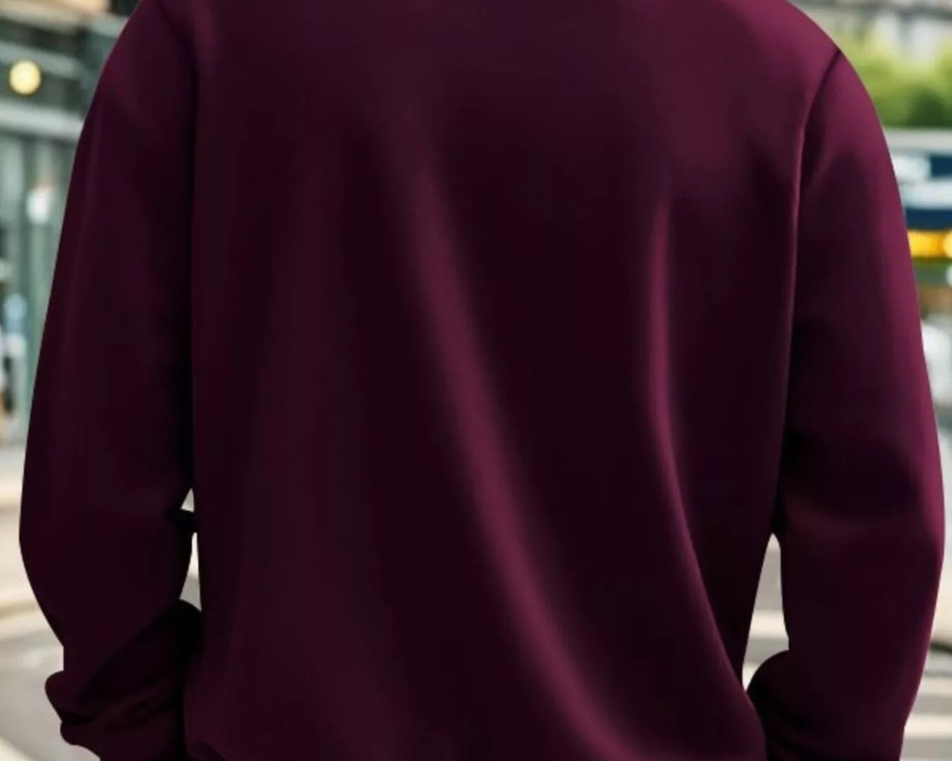 NEWYORKLISTED ATLAS MEN'S COLLECTION: Person wearing a maroon half-zip sweatshirt on a city street.