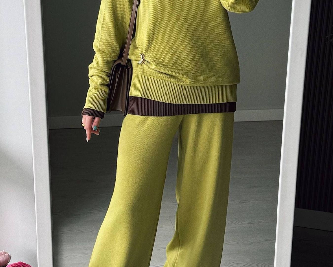 NEWYORKLISTED Comfort Collection: Person wearing a green sweater and pants standing in front of a mirror.