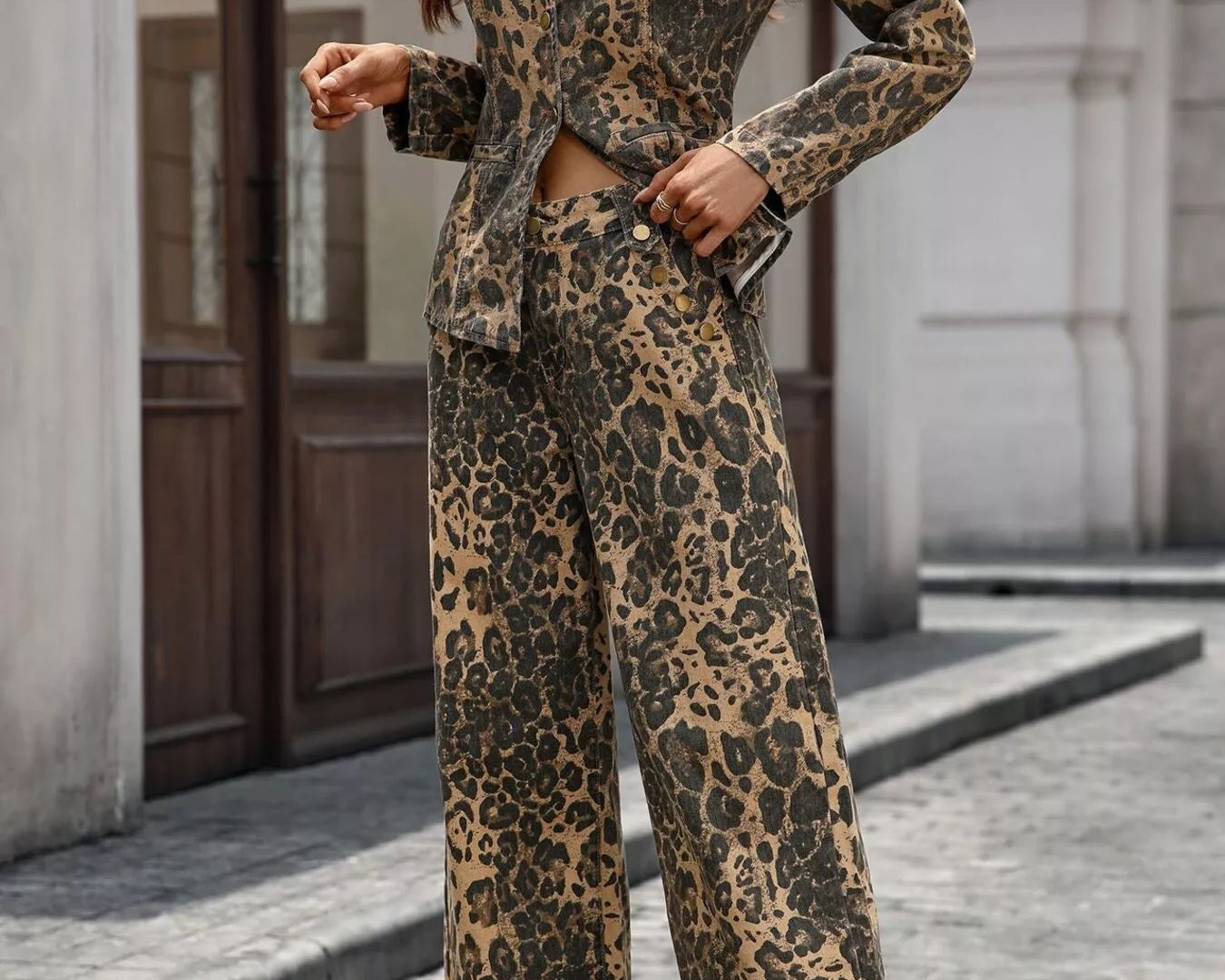 NEWYORKLISTED STYLE COLLECTION: Woman wearing a leopard print outfit standing on a street.