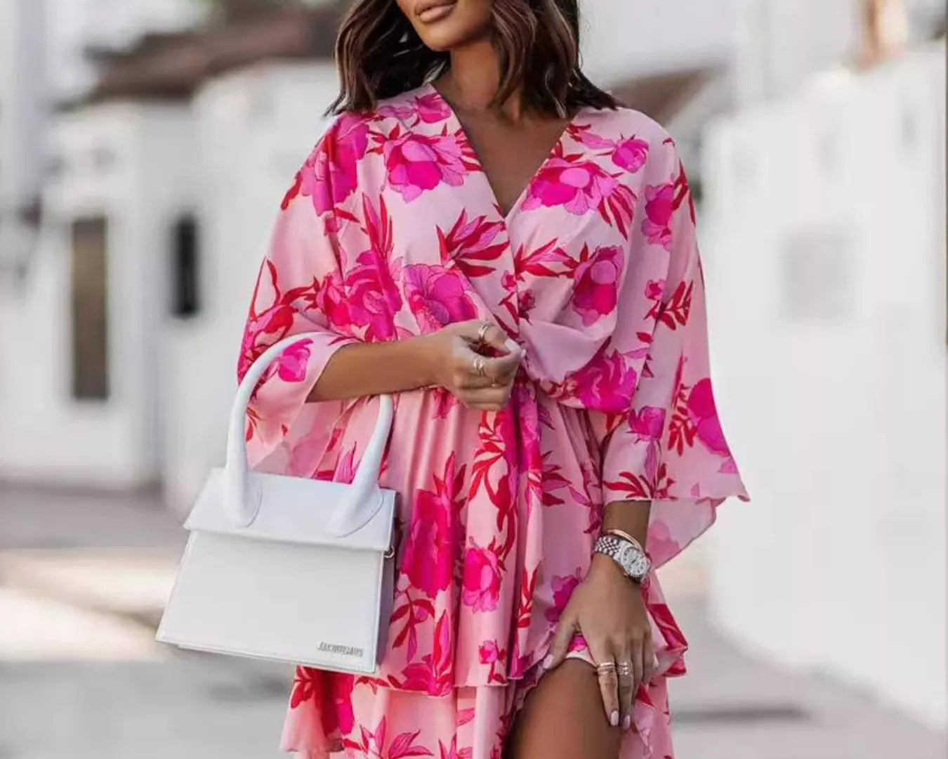 NEWYORKLISTED STYLE COLLECTION: Woman wearing a pink floral dress with a blurred background