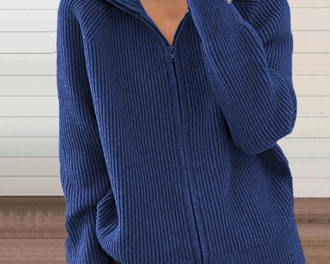 NEWYORKLISTED STYLE COLLECTION: Person wearing a blue ribbed zip-up sweater against a neutral background
