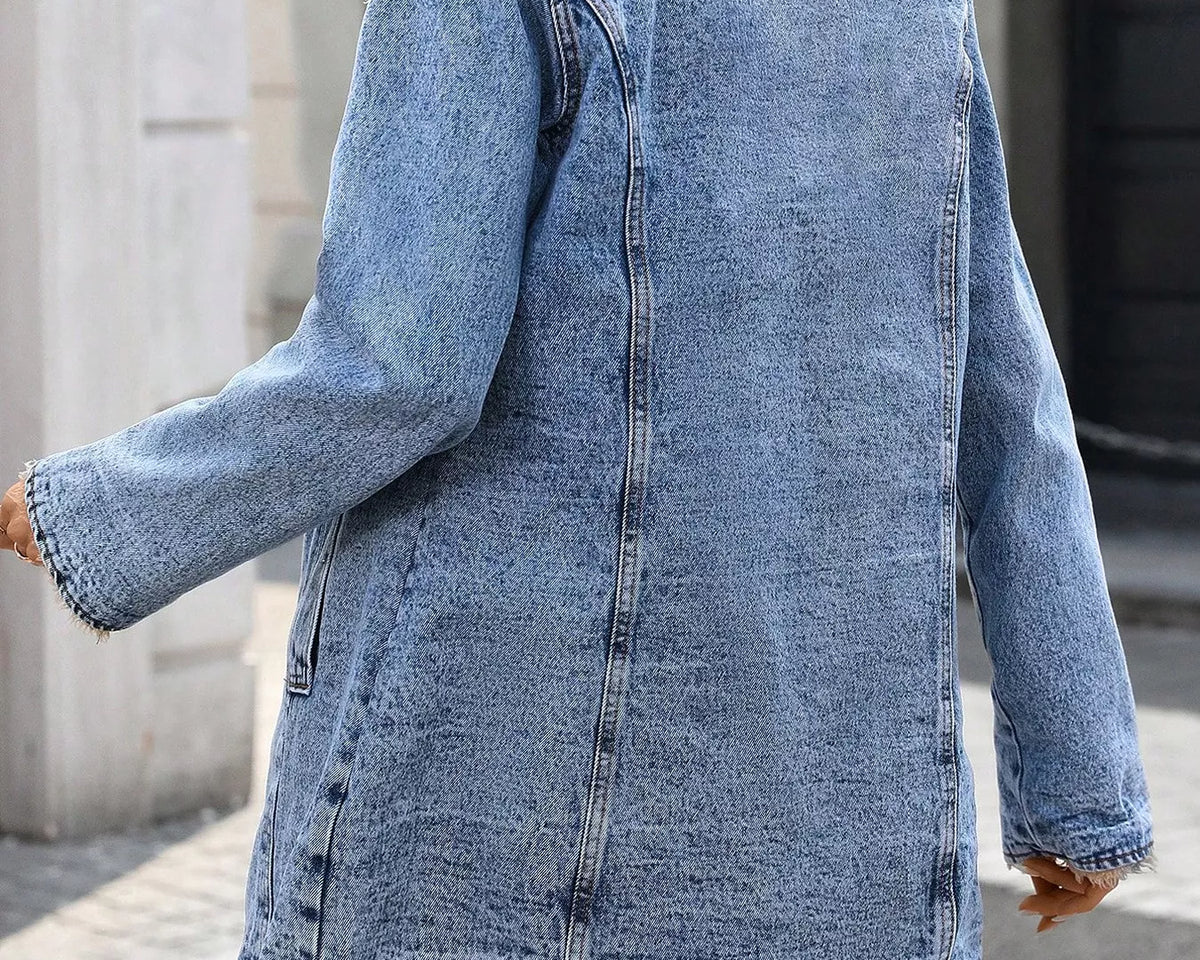 NEWYORKLISTED STYLE COLLECTION: A woman wearing a light blue denim jacket with a beige faux-fur collar, photographed from the back in an outdoor street setting.