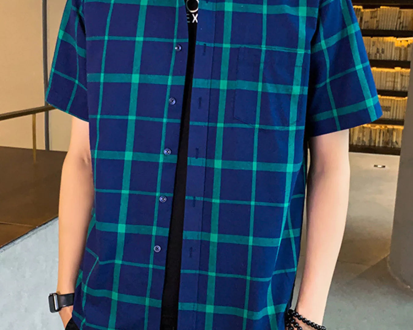 NEWYORKLISTED ATLAS MEN'S COLLECTION: Person wearing a blue and green plaid shirt indoors.
