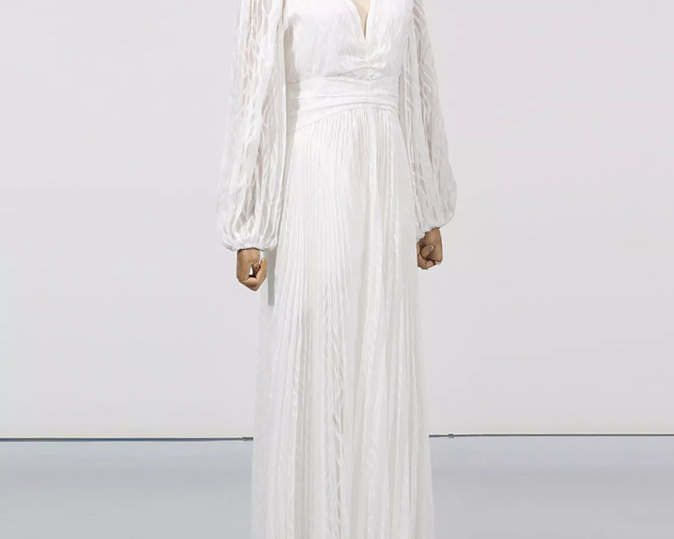 NEWYORKLISTED STYLE COLLECTION: White dress on a mannequin against a plain background